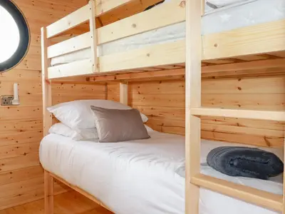 a bedroom with two bunk beds in a log cabin at Stargaze in Truro
