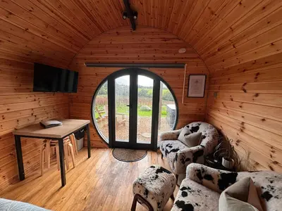a room with a large window in a wooden cabin at Stargaze in Truro