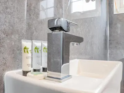 a bathroom sink with a faucet and threeials at Sunflower in Redruth