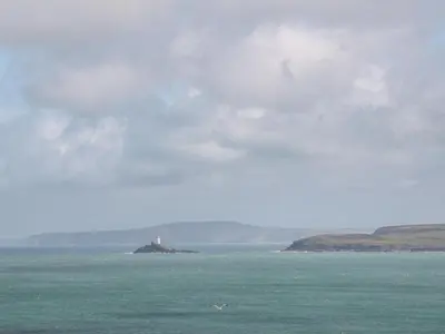 a lighthouse on an island in the middle of the ocean at Sunflower in Redruth