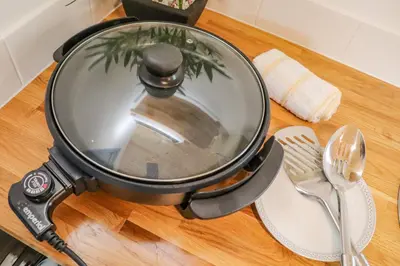 a frying pan on a table with a spatula at Sunflower in Redruth