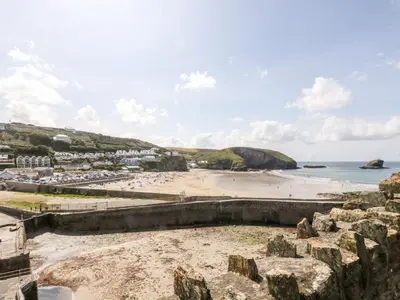 a view of a beach with rocks and the ocean at Rose in Redruth