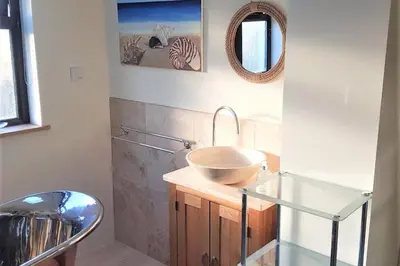 a bathroom with a bowl sink and a mirror at High quality detached house with parking St. Ives in St Ives