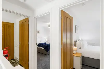a bedroom with a bed and a mirror at Rosevilla Farmhouse in Portreath