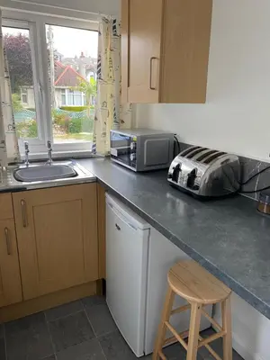 a kitchen with a counter with a microwave and a sink at 24trenance in Newquay