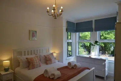 a bedroom with a bed with two towels on it at Oakroyd in Gorran Haven