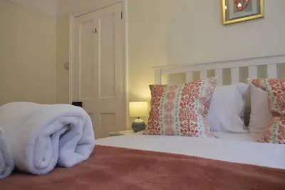 a bedroom with a bed with a towel on it at Oakroyd in Gorran Haven