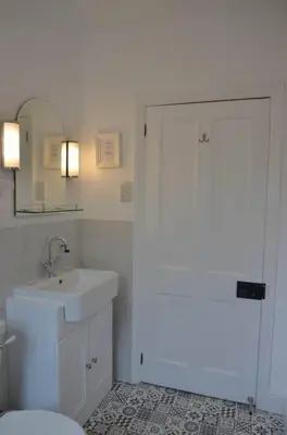 a bathroom with a white toilet and a sink at Oakroyd in Gorran Haven