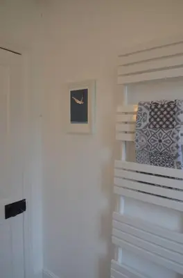 a white refrigerator with a picture on the wall at Oakroyd in Gorran Haven