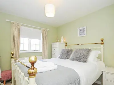 a bedroom with two beds and a window at Quay House in St Austell
