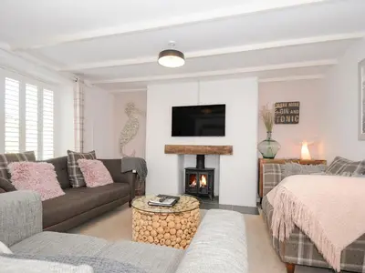 a living room with a couch and a fire place at Quay House in St Austell