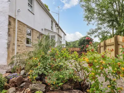 a garden in front of a house at The Hideaway in Chacewater