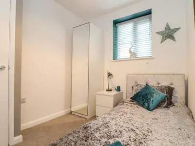 a bedroom with a bed and a mirror at The Hideaway in Chacewater