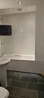 a bathroom with a toilet and a sink and a tub at Fore Street Bodmin in Bodmin