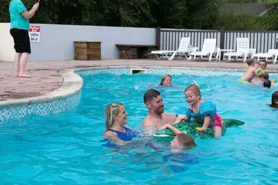 a group of people playing in a swimming pool at Newquay Bay Resort 181 in Porth