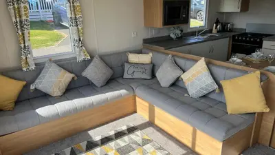 a couch in a kitchen with pillows on it at Newquay Bay Resort 181 in Porth