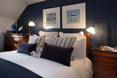 a bedroom with a bed with white sheets and pillows at The Lambing Shed, Cornwall in Altarnun