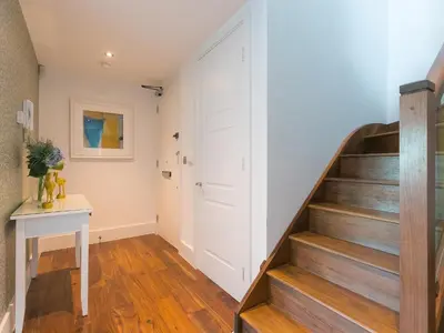 a staircase in a home with wooden floors at Porthminster Penthouse in St Ives