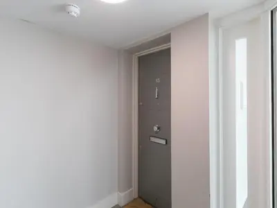 a hallway with a door in the corner of a room at Porthminster Penthouse in St Ives