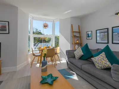 a living room with a couch and a table at Waters Watch in St Ives