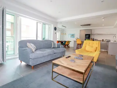 a living room with a couch and a table at 30 Cliff Edge in Newquay