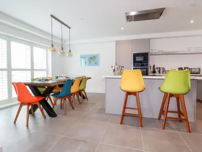a kitchen and dining room with a table and chairs at 30 Cliff Edge in Newquay