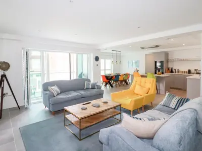 a living room with two couches and a table at 30 Cliff Edge in Newquay