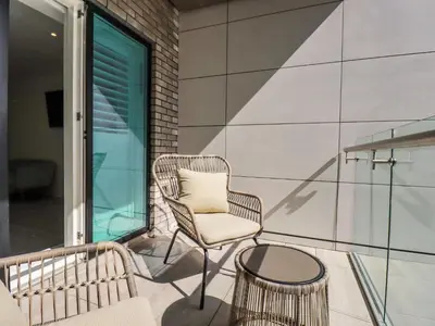 a chair and a table on a balcony at 30 Cliff Edge in Newquay