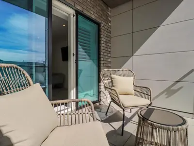 a balcony with two chairs and a couch and a table at 30 Cliff Edge in Newquay