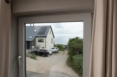 a view from a sliding glass door of a house at Spindrift, St Ives in St Ives