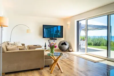 a living room with a couch and a table at Finest Retreats - Avalon Sea Views in Downderry