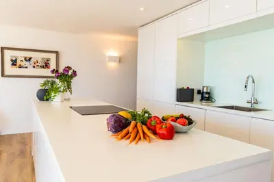 a bowl of vegetables sitting on a counter in a kitchen at Finest Retreats - Avalon Sea Views in Downderry