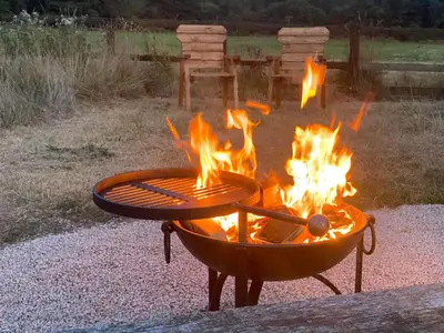 a fire pit with flames in a yard at Roosters Retreat in Launceston