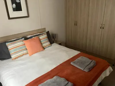 a bedroom with a bed with two towels on it at Tranquil Retreat at River Valley Country Park in Penzance