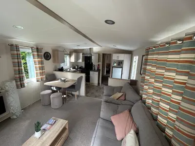 a living room with a couch and a table at Tranquil Retreat at River Valley Country Park in Penzance