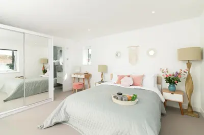 a bedroom with a bed with a basket of fruit on it at Sandy Cove in Penzance