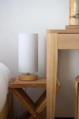 a wooden table with a lamp on top of it at 4 Bedroom Cottage with panoramic Harbour views in Falmouth