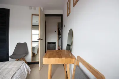 a room with a wooden table in a bedroom at 4 Bedroom Cottage with panoramic Harbour views in Falmouth
