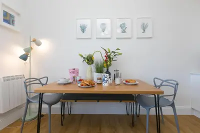 a dining room table with chairs and plates of food on it at Sea Bre in St Ives