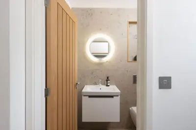 a bathroom with a sink and a mirror at Treheyl, Pentire, Newquay in Newquay