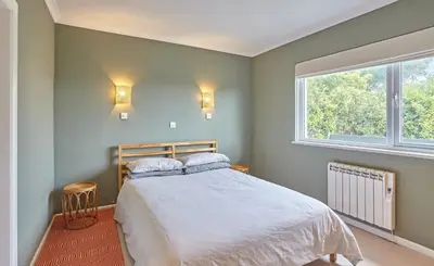 a bedroom with a bed and a window at Howlyek, in St Agnes Village in St. Agnes