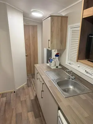 a kitchen with a sink and a counter top at Oakley Newquay Bay Resorts in Porth