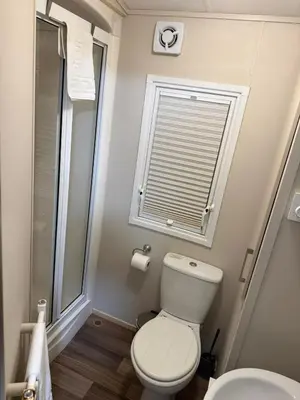 a bathroom with a toilet and a window at Oakley Newquay Bay Resorts in Porth