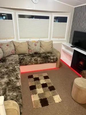 a living room with a couch and a tv at Oakley Newquay Bay Resorts in Porth