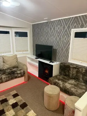 a living room with a flat screen tv and a couch at Oakley Newquay Bay Resorts in Porth