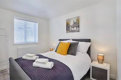 a bedroom with a large bed with towels on it at 2022 Stylish Flat in Central Hayle in Hayle