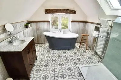 a bathroom with a tub and a sink at Daydreamer Cottage in Padstow