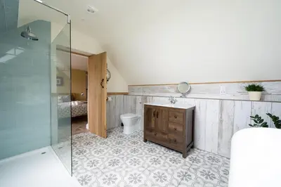 a bathroom with a toilet and a glass shower at Daydreamer Cottage in Padstow