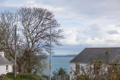 a street light next to a house and a tree at Ocean Gate in Carbis Bay
