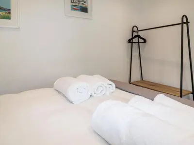 a pile of towels sitting on top of a bed at Ocean Gate in Carbis Bay